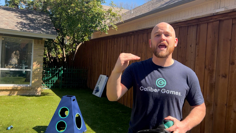 Man in backyard with Towerball setup talking about game ratings to camera.