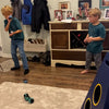 Two children playing Towerball indoors